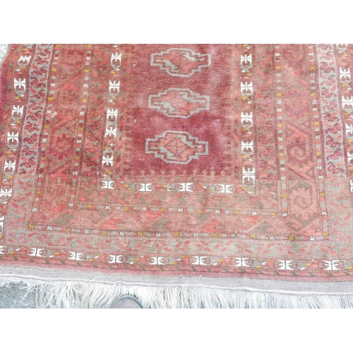 1138 - A Bokhara carpet with geometric designs on a brick red field, 83