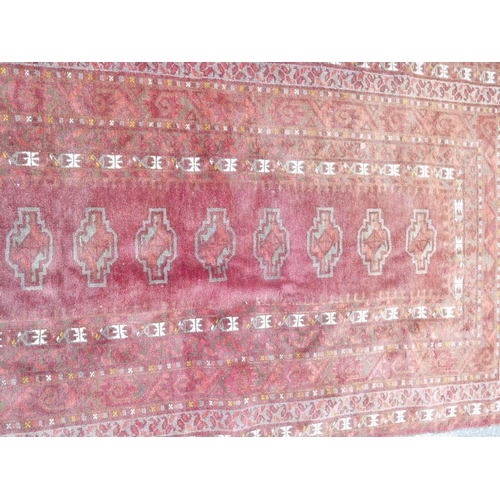 1138 - A Bokhara carpet with geometric designs on a brick red field, 83