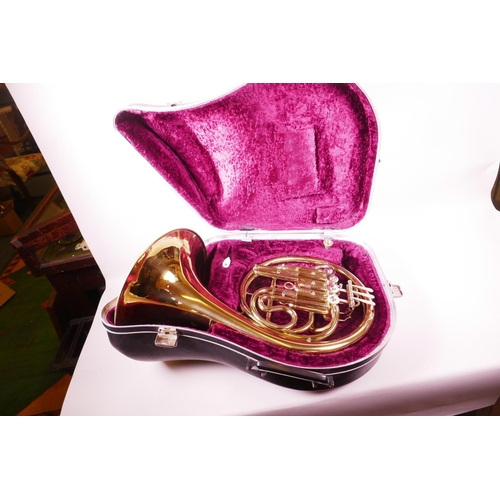 12 - A brass French horn in fitted case