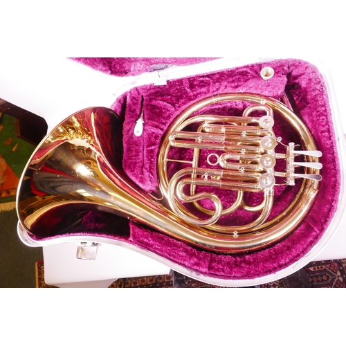 12 - A brass French horn in fitted case