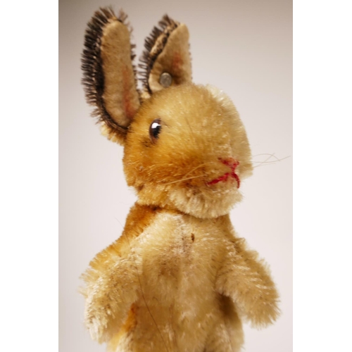 34 - A 1952/53 Steiff begging rabbit, golden mohair, fixed limbs, brown and black glass eyes, red stitchi... 