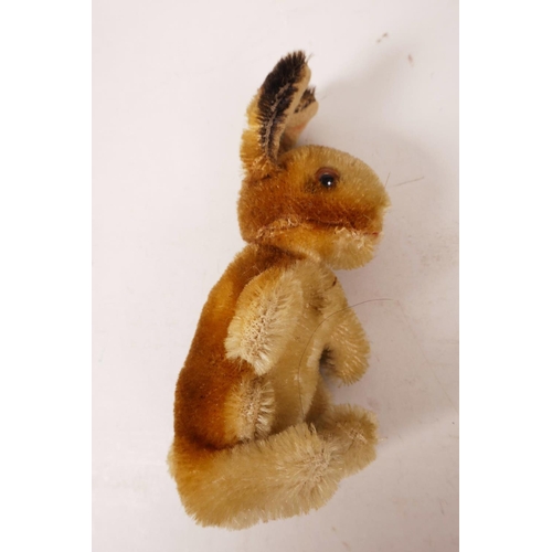 34 - A 1952/53 Steiff begging rabbit, golden mohair, fixed limbs, brown and black glass eyes, red stitchi... 