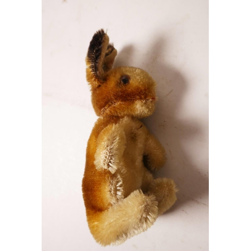 34 - A 1952/53 Steiff begging rabbit, golden mohair, fixed limbs, brown and black glass eyes, red stitchi... 