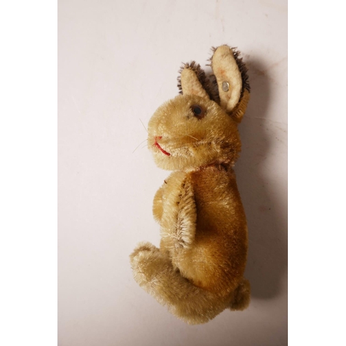 34 - A 1952/53 Steiff begging rabbit, golden mohair, fixed limbs, brown and black glass eyes, red stitchi... 