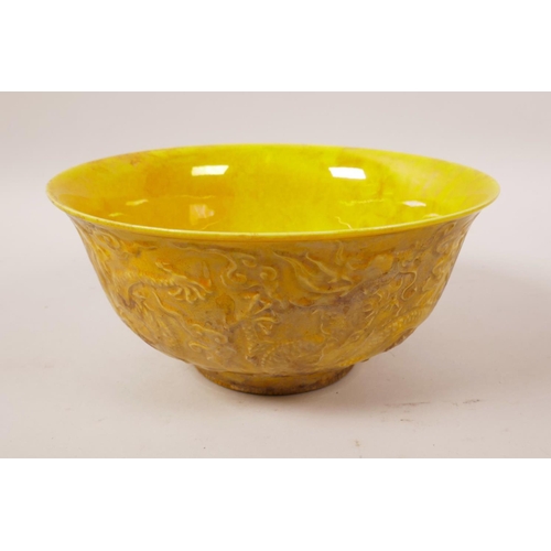 38 - A yellow ground porcelain bowl with raised dragon decoration, 6 character mark to base, 6½