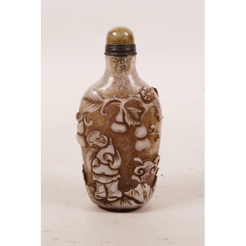 49 - A Peking glass snuff bottle with carved decoration of children playing, 3½