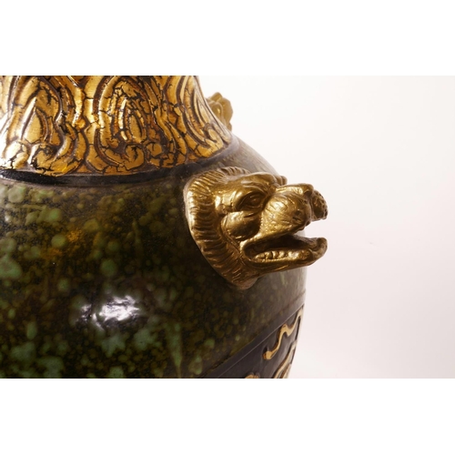 61 - A large Chinese mottled green glazed pottery vase with ormolu style mounts and lion mask handles, th... 