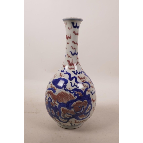 64 - A Chinese blue and white porcelain pear shaped vase with kylin decoration and red highlights, 9