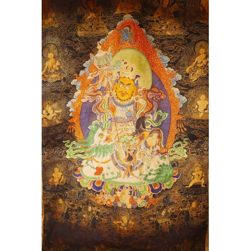 25 - A Sino-Tibetan printed thangka depicting a wrathful deity encircled by depictions of Buddha, 43