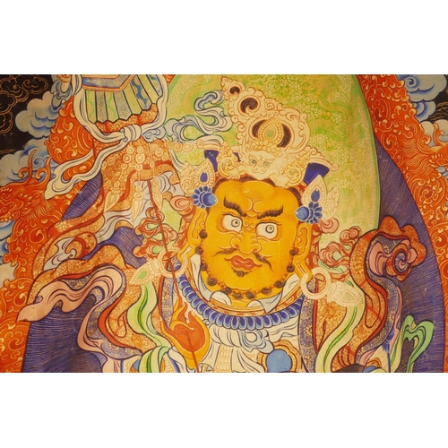 25 - A Sino-Tibetan printed thangka depicting a wrathful deity encircled by depictions of Buddha, 43