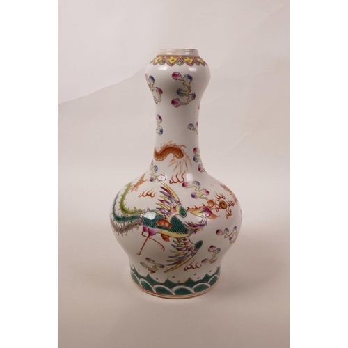 38 - A Chinese polychrome porcelain garlic head shaped vase with enamelled decoration of a dragon chasing... 