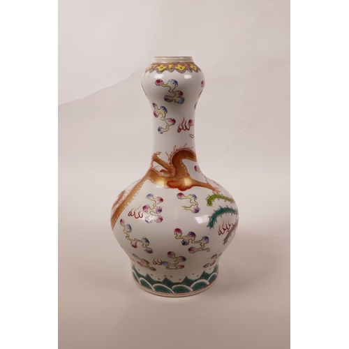 38 - A Chinese polychrome porcelain garlic head shaped vase with enamelled decoration of a dragon chasing... 