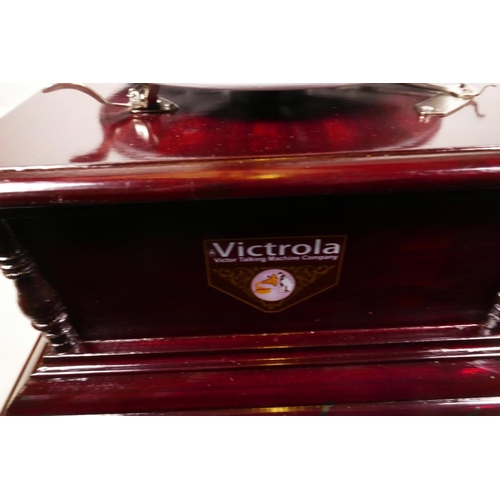 42 - A replica Victorola wind up horn gramophone with mahogany case and brass horn, 14½