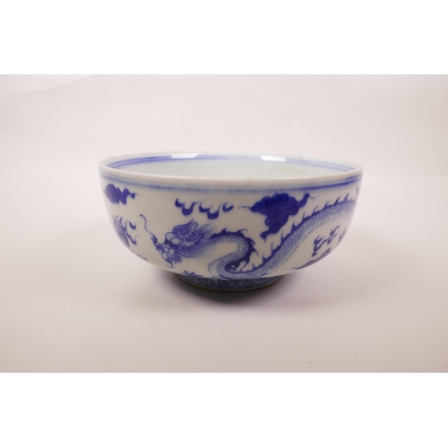 5 - A Chinese blue and white porcelain bowl decorated with a dragon chasing the flaming pearl, 6 charact... 