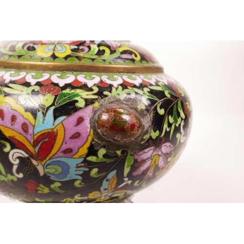 6 - A Chinese black ground cloisonné vase, decorated with butterflies and lotus flowers, A/F repair, 12