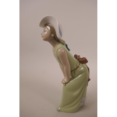 11 - Two Lladro figurines, 'Curious Girl with Straw Hat', #5009, and the other 'Bashful Girl with Straw H... 