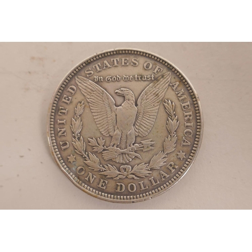 23 - A USA silver Morgan dollar coin minted in Philadelphia and dated 1921; a USA silver Kennedy 1964 hal... 