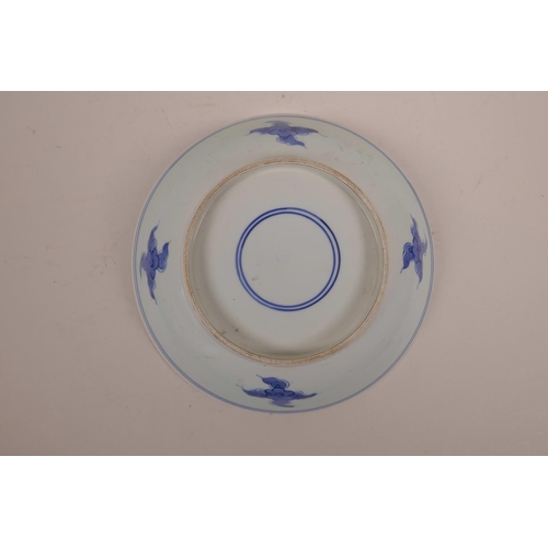 33 - A Chinese blue and white porcelain dish decorated with a figure riding an ox, 8½