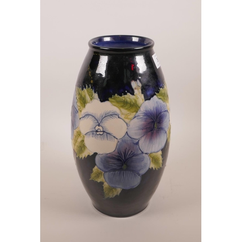 36 - A Moorcroft style blue glazed pottery vase with floral decoration, 12