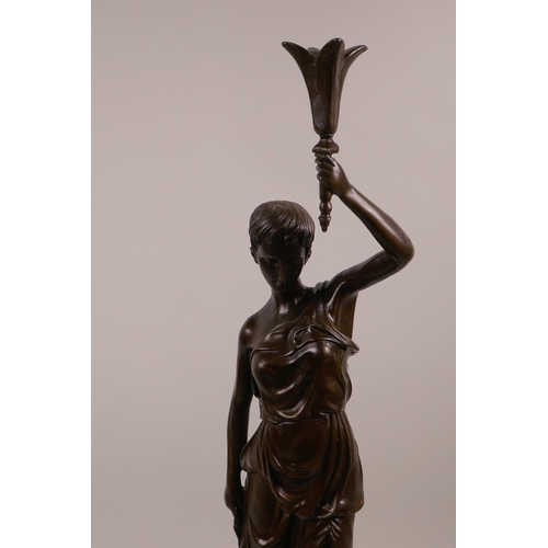 50 - A bronze figure of a classical lady holding a sceptre aloft, on a black marble base, 20