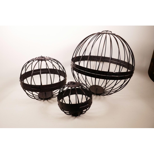 61 - A set of three graduated open wirework hanging planters, largest 4½