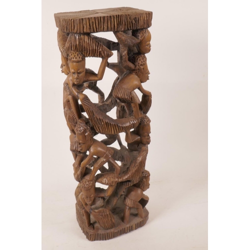 2 - An African hardwood lamp base carved as a tower of figures, 18½