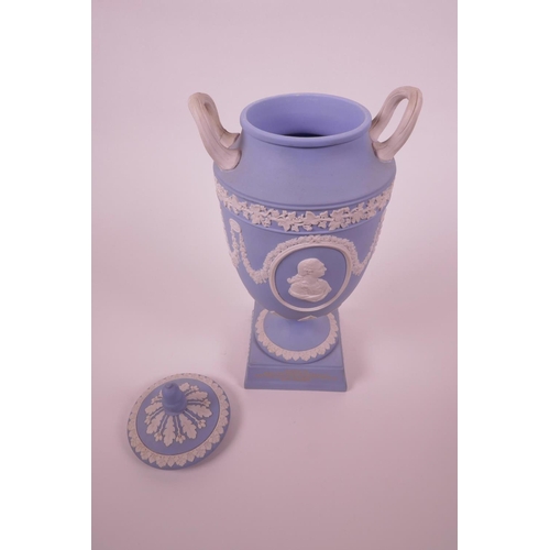 27 - A Wedgwood blue Jasperware two handled urn and cover on stemmed support, inscription 'West End Theat... 