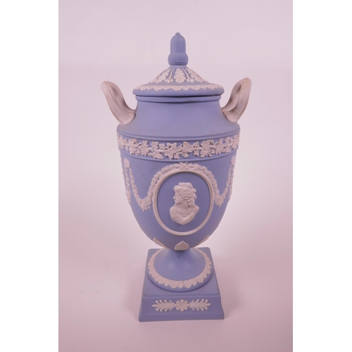 27 - A Wedgwood blue Jasperware two handled urn and cover on stemmed support, inscription 'West End Theat... 