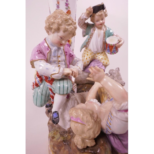 29 - A C19th porcelain figural group, with the crossed swords Meissen blue mark beneath, modelled with a ... 