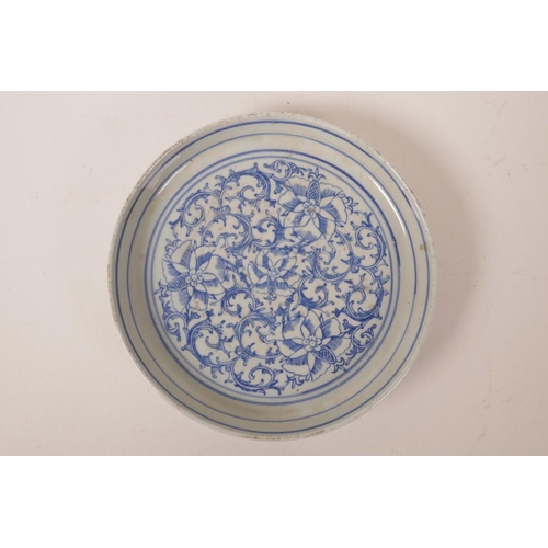 68 - A Chinese blue and white porcelain shallow dish with scrolling lotus flower decoration, 7½