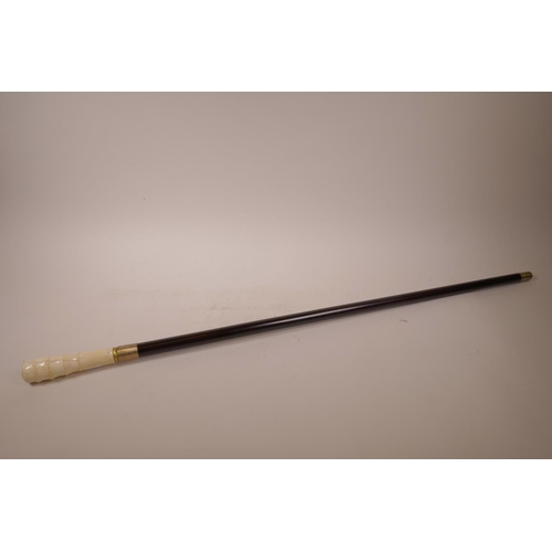 11 - A walking cane with carved bone handle and metal tip, (WF), 35