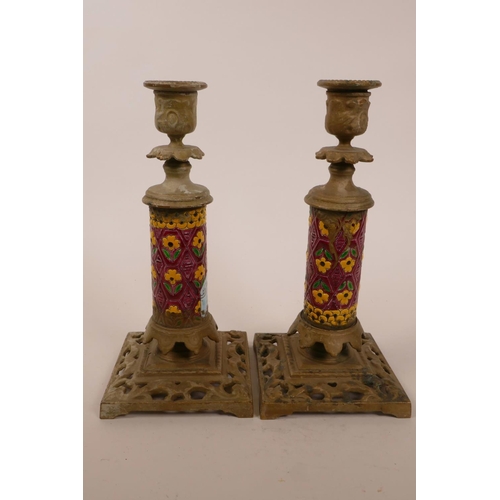 21 - A pair of candlesticks with cast brass bases and enamel decorated columns,possibly Indian, 9