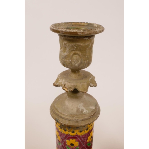 21 - A pair of candlesticks with cast brass bases and enamel decorated columns,possibly Indian, 9