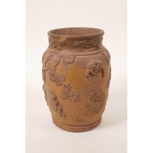 35 - A Chinese earthenware jar with raised decoration of a figure and dragon, A/F losses and chips, 7