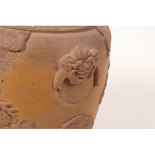 35 - A Chinese earthenware jar with raised decoration of a figure and dragon, A/F losses and chips, 7