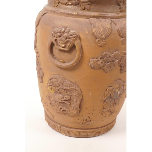 35 - A Chinese earthenware jar with raised decoration of a figure and dragon, A/F losses and chips, 7