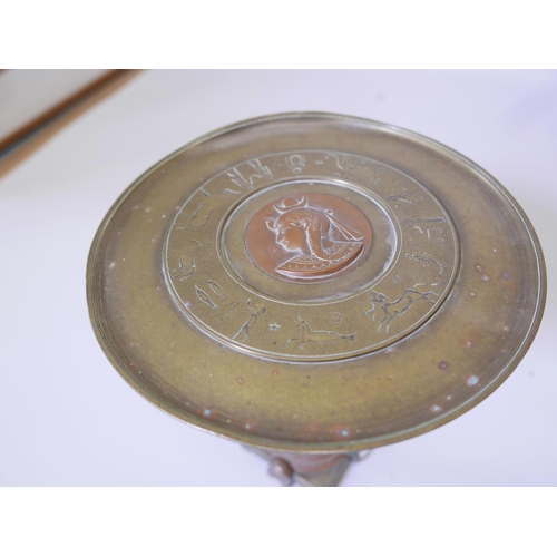 54 - A French Art Deco  brass and copper tazza, the top with engraved zodiac figures and a central copper... 