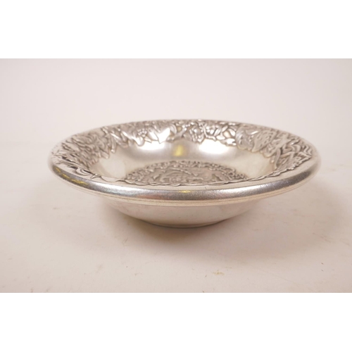 9 - A Chinese metal bowl with embossed decoration, 5½