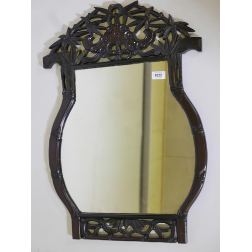 1171 - A Chinese pagoda shaped, carved hardwood frame wall mirror, with pierced decoration of bamboo and ba... 