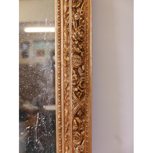 1173 - A French style gilt wood and composition wall mirror, the top flanked by two putti, some losses, 44