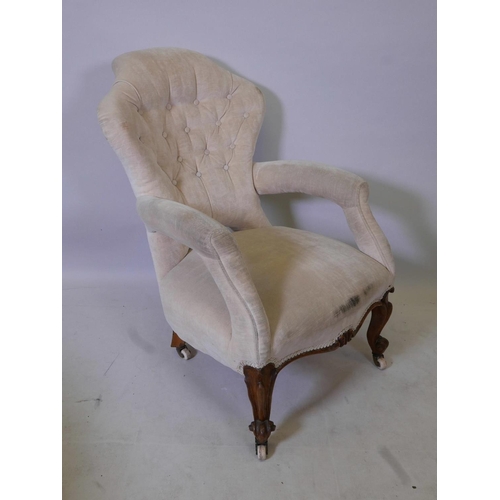 1172 - A Victorian walnut open arm, shaped back easy chair, 35