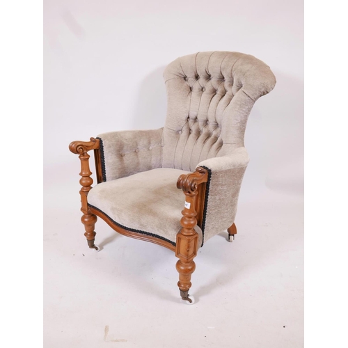 1180 - A C19th walnut show frame armchair with scrolled arms and serpentine front, raised on turned support... 