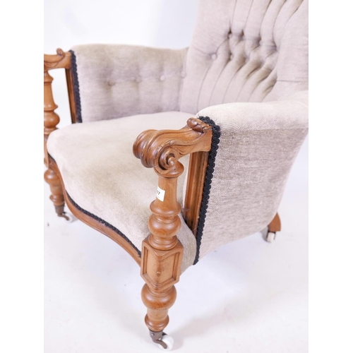 1180 - A C19th walnut show frame armchair with scrolled arms and serpentine front, raised on turned support... 