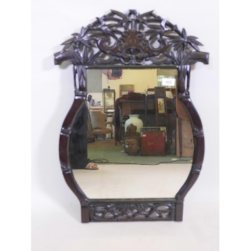 1171 - A Chinese pagoda shaped, carved hardwood frame wall mirror, with pierced decoration of bamboo and ba... 