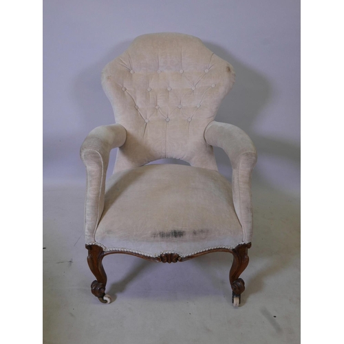 1172 - A Victorian walnut open arm, shaped back easy chair, 35