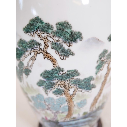 12 - A Chinese Republic porcelain vase decorated with figures in a forest and lake landscape, calligraphy... 