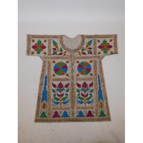 62 - An Islamic linen tunic, decorated with polychrome patterns and all over calligraphy, 42