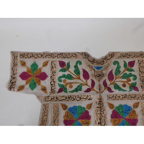 62 - An Islamic linen tunic, decorated with polychrome patterns and all over calligraphy, 42