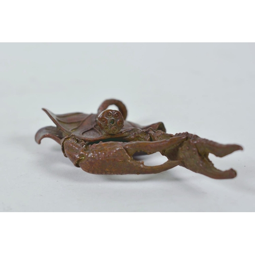 11 - An unusual Chinese bronzed metal model of a mythical creature, together with a parrot letter opener,... 