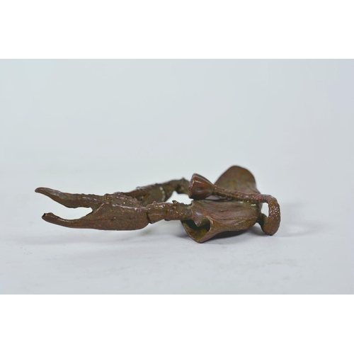 11 - An unusual Chinese bronzed metal model of a mythical creature, together with a parrot letter opener,... 